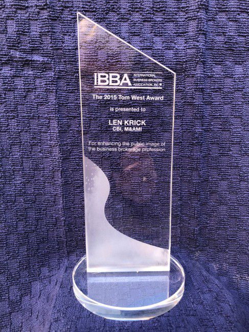 A clear glass award sitting on top of a table.